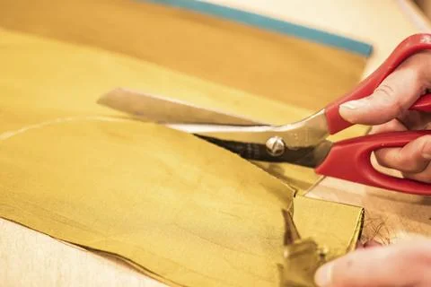 Fabric Cutting Process With Scissors In Tailoring Workshop Stock Photos
