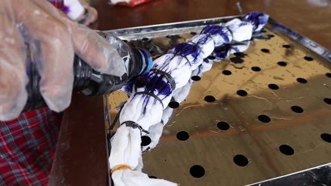 Fabric dyeing process, pouring dye using bottles Stock Footage 304848498
