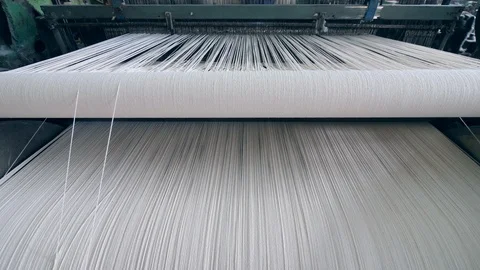 Fabric is getting sewn of white threads. Textiles Production Line Video stock 111335517