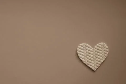 Fabric heart on the table. Copy space, pale brown photo Stock-Fotos
