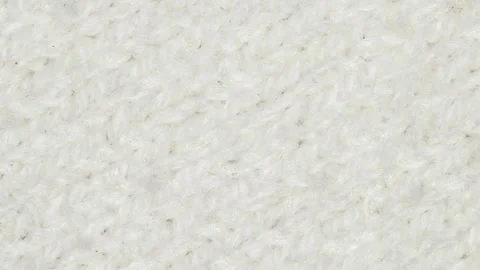 Fabric knitted with white threads close-up, rotating Stock Footage 242360685