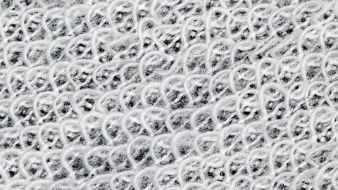Fabric made of white threads with wavy seams, rotating Stock Footage 243987536