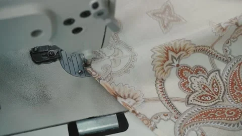 The fabric moves out from under the needle of the sewing machine Stock Footage 130507348