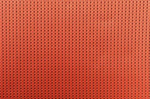 Fabric orange colored background with light penetrating through Stock Photos