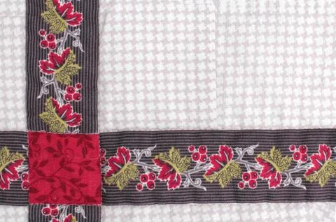 Fabric patchwork from colored fabrics with handmade folk ornament as a backgr Foto stock