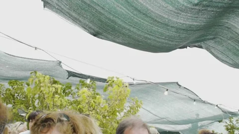 Fabric to protect from the rain at a big table and festival in Ikaria Stock Footage 144943660