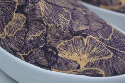 Fabric purple, orange background with a pattern of leaves. Stock Photos