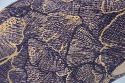 Fabric purple, orange background with a pattern of leaves. Stock Photos