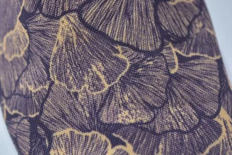 Fabric purple, orange background with a pattern of leaves. Stock Photos