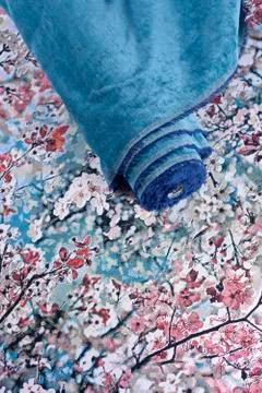 Fabric roll on patterned textile underground Stock Photos