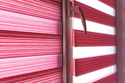 Fabric roller blinds on the window. Stock Photos