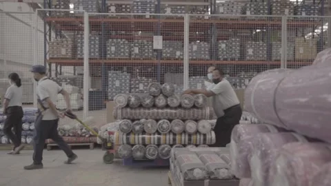 Fabric rolls are transported in a stroller by an automatic sewing machine Stock Footage 248798360