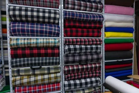 Fabric rolls creating colorful texture in textile store Stock Photos