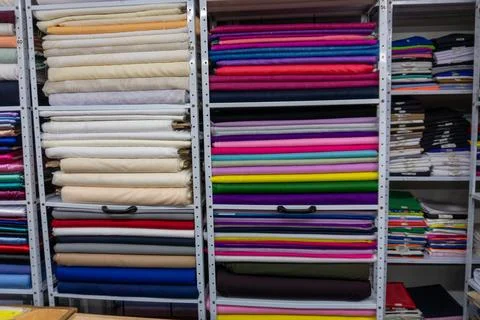 Fabric rolls creating colorful texture in textile store Stock Photos
