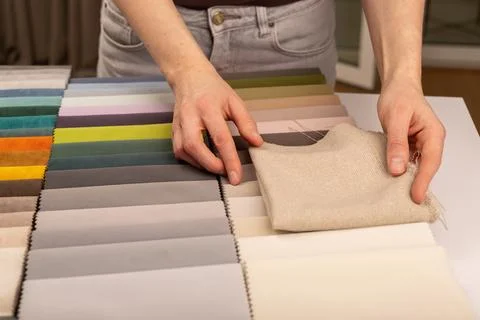 Fabric sample book with neutral beige upholstery tissue. Specialist choosin.. Stock-Fotos
