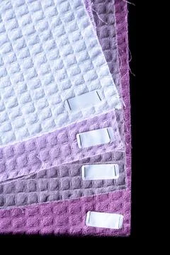 Fabric samples of different colors and textures displayed together on black.. Фото
