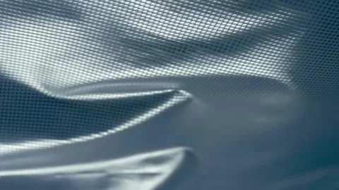 Fabric with a shiny checkered pattern flutters in the wind Stock Footage 297776960