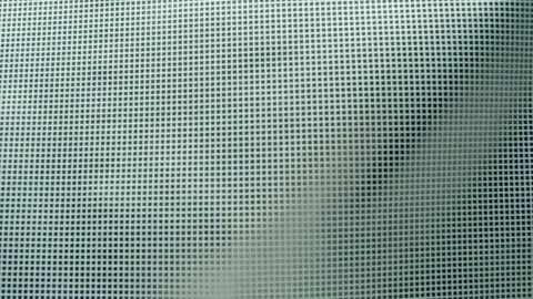 Fabric with a shiny checkered pattern flutters in the wind Video stock 303170660