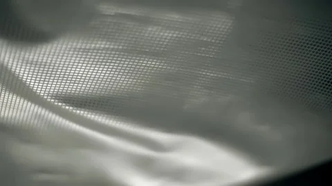 Fabric with a shiny checkered pattern flutters in the wind Stock Footage 303174892