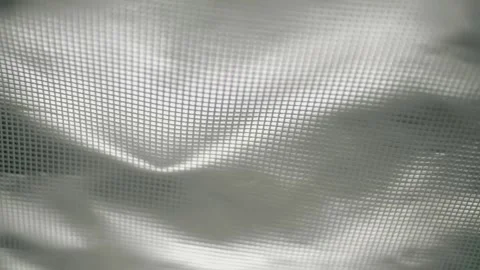 Fabric with a shiny checkered pattern flutters in the wind Stock Footage 303179033