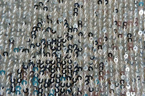 Fabric with silver sequins. Textured background Stock Photos