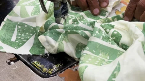 Fabric stitching process with sewing machine and scissors nearby Видео 332912817