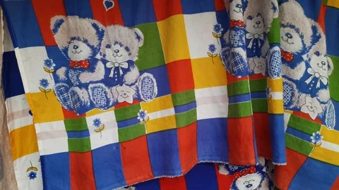 Fabric with teddy bear print hanging on clothesline. Static, close up Stock Footage 173189631