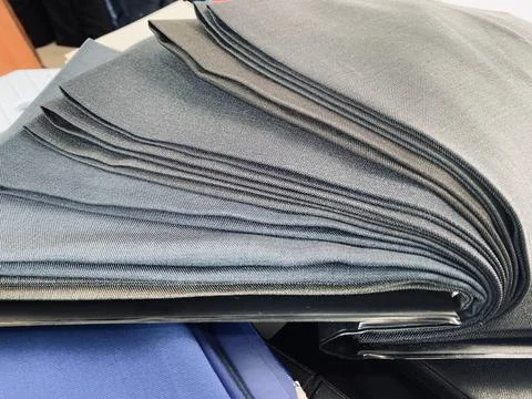 Fabric textile sample for men suits jacket on the table Stock Photos