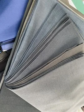 Fabric textile sample for men suits jacket on the table Stock Photos
