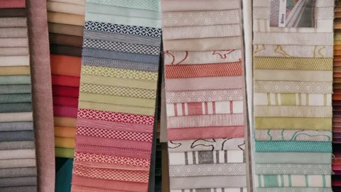 Fabrics in Various Colors and Patterns Options Hang from Wall of Stock Footage 140585676