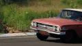 Fabulous American vintage car Chevrolet Impala driving over the road HD Footage