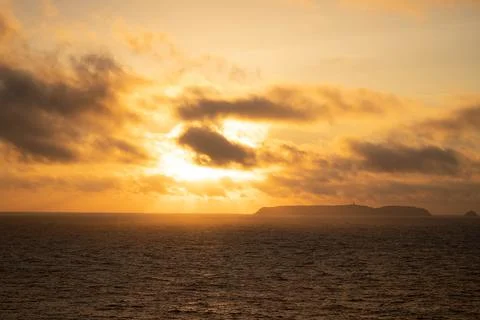 Fabulous sunset, the sun sets behind the island in the distance Stock Photos