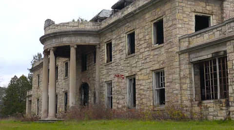 Facade of an abandoned and spooky old boarding school or mansion in the Vídeos de archivo 65966655
