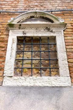 Facade of the ancient building with a window and lattice Stock Photos