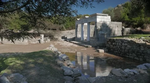 Facade of the ancient temple with columns reflection in the water, Kaunos Stock Footage 58864680