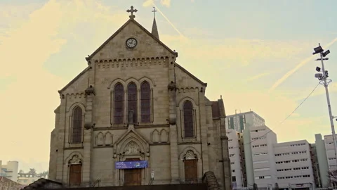 The facade and bell tower of the neo-Gothic church of Firminy Stock Footage 268623032