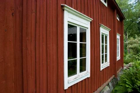 Facade and windows of typical red scandinavian wooden farmhouse Stock Photos