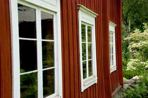 Facade and windows of typical red scandinavian wooden farmhouse Stock Photos