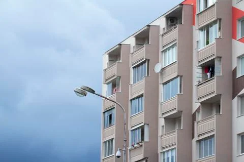 Facade of apartment building over cloudy sky Stock Photos
