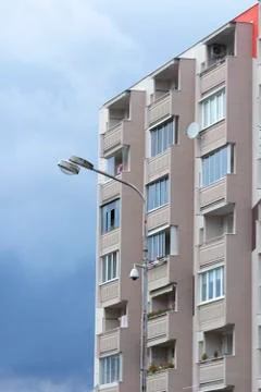 Facade of apartment building over cloudy sky Stock Photos