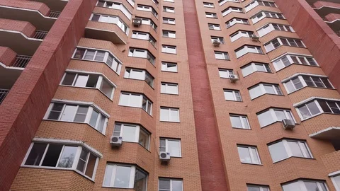 Facade of an apartment building. Reflection of the sky in the windows 4k Stock Footage 129927649