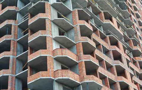 Facade of a block of flats under construction. Industry Stock Photos