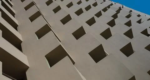 Facade of brown building with square patterns closeup background Foto stock