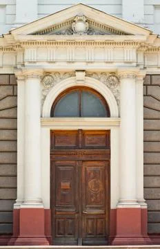 Facade of building in classical style with gamble and columns. Stock Photos