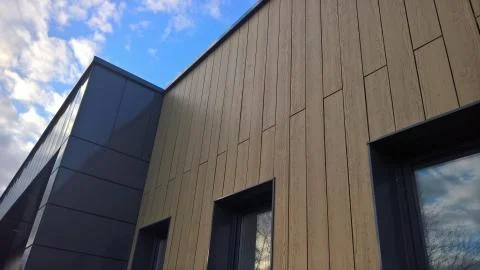 The facade of the building is colored tiled Stock Photos