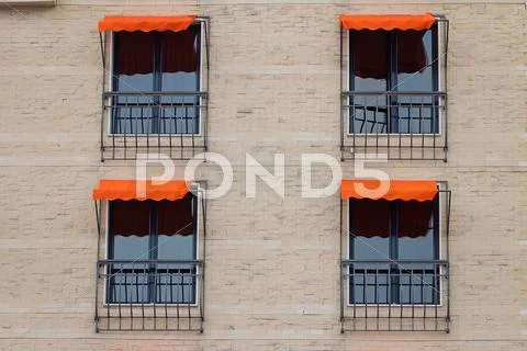 Facade Of Building With Orange Awning Stock Photos