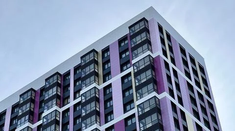 The facade of the building in purple,geometric patterns from windows and Stock Photos