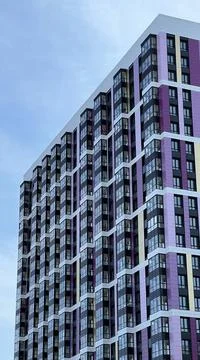 The facade of the building in purple,geometric patterns from windows and Stock Photos