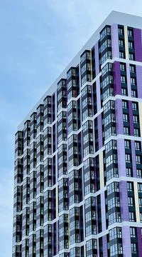 The facade of the building in purple,geometric patterns from windows and Stock Photos