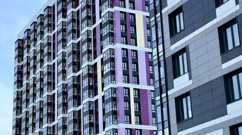 The facade of the building in purple,geometric patterns from windows and Stock Photos